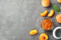 Flat lay composition with jar of tasty peach jam and fresh fruit