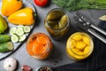 Flat lay composition with jars of pickled and fresh vegetables