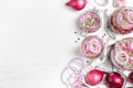 Flat lay composition with jars of pickled onions on white wooden table