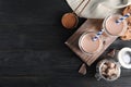 Flat lay composition with jars of tasty chocolate milk and space for text on wooden background. Royalty Free Stock Photo