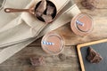 Flat lay composition with jars of tasty chocolate milk on wooden background Royalty Free Stock Photo