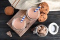 Flat lay composition with jars of tasty chocolate milk on wooden background Royalty Free Stock Photo