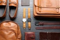 Flat lay composition with leather bags, shoes and accessories on wooden table