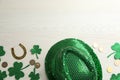 Flat lay composition with leprechaun hat on white wooden table, space for text. St Patrick`s Day celebration Royalty Free Stock Photo