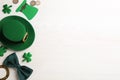 Flat lay composition with leprechaun hat on white wooden table, space for text. St Patrick`s Day celebration Royalty Free Stock Photo