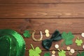 Flat lay composition with leprechaun hat on wooden table, space for text. St Patrick`s Day celebration Royalty Free Stock Photo