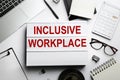 Flat lay composition of lightbox with phrase INCLUSIVE WORKPLACE on white table Royalty Free Stock Photo