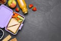 Flat lay composition with lunch box and tasty healthy food on grey table., space for text. School dinner Royalty Free Stock Photo