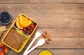 Flat lay composition with lunch box and tasty healthy food on wooden table, space for text. School dinner Royalty Free Stock Photo