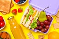 Flat lay composition with lunch box and tasty healthy food on yellow background. School dinner Royalty Free Stock Photo