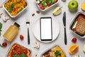 Flat lay composition with lunchboxes and smartphone on white wooden table. Healthy food delivery