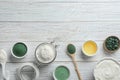 Flat lay composition with made spirulina facial mask on white wooden table. Space for text Royalty Free Stock Photo