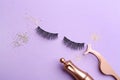 Flat lay composition with magnetic eyelashes and accessories on violet background Royalty Free Stock Photo