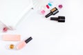 Flat lay composition of Manicure tools, UV lamp and nail polishes on a white background. Place for text