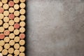 Flat lay composition with many corks of wine bottles on grey table. Space for text