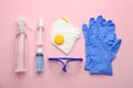 Flat lay composition with medical gloves, mask and hand sanitizers on pink background Royalty Free Stock Photo