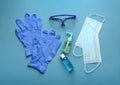 Flat lay composition with medical gloves, masks and hand sanitizers on blue background Royalty Free Stock Photo