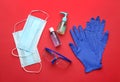 Flat lay composition with medical gloves, masks and hand sanitizers on red background Royalty Free Stock Photo