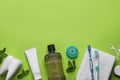 Flat lay composition with mouthwash and other oral hygiene products on light green background. Space for text Royalty Free Stock Photo