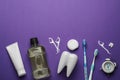 Flat lay composition with mouthwash and other oral hygiene products on purple background. Space for text Royalty Free Stock Photo