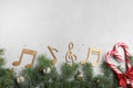 Flat lay composition with music notes on light grey background, space for text. Christmas celebration Royalty Free Stock Photo