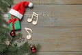 Flat lay composition with music notes on wooden background, space for text. Christmas celebration Royalty Free Stock Photo