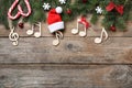 Flat lay composition with music notes on wooden background, space for text. Christmas celebration Royalty Free Stock Photo