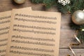 Flat lay composition with music sheets on wooden background. Christmas celebration Royalty Free Stock Photo