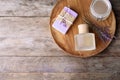 Flat lay composition with natural herbal oil, soap and lavender flowers on wooden background. Space for text Royalty Free Stock Photo