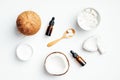 Flat lay composition with natural organic coconut cosmetic for body care. Top view coconut, essential oil, moisturizer cream on