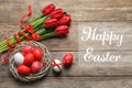 Flat lay composition of nest with painted eggs and text Happy Easter Royalty Free Stock Photo