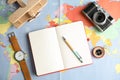 Flat lay composition with notebook and camera on world map, space for text Royalty Free Stock Photo