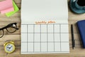 Flat lay composition of notebook with weekly plan on wooden table