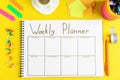 Flat lay composition of notebook with weekly plan on yellow background