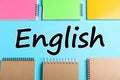 Flat lay composition with notebooks on blue background. Learning English Royalty Free Stock Photo