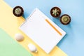 Flat lay composition with notepad, three green cactuses, two seashells on pastel yellow-blue-green background. Royalty Free Stock Photo