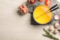 Flat lay composition with oil pot, meat fondue ingredients on light background