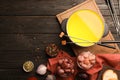 Flat lay composition with oil pot, meat fondue ingredients on wooden background
