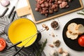 Flat lay composition with oil pot and meat fondue ingredients