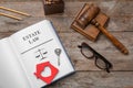 Flat lay composition with open book, gavel and house key on wooden background. Estate law concept Royalty Free Stock Photo