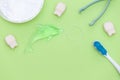 Flat lay composition with care products on green background. Dental care and healthy teeth concept. Copy space Royalty Free Stock Photo