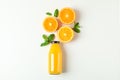 Flat lay composition with orange juice in bottle, oranges and mint on white background, space for text. Citrus drink Royalty Free Stock Photo