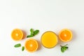 Flat lay composition with orange juice, oranges and mint on white background, space for text. Citrus drink Royalty Free Stock Photo