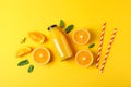 Flat lay composition with oranges, tubules and orange juice in bottle, space for text Royalty Free Stock Photo