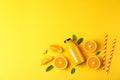 Flat lay composition with oranges, tubules and orange juice in bottle, space for text Royalty Free Stock Photo