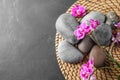 Flat lay composition with orchid  and spa stones on grey table. Space for text Royalty Free Stock Photo