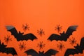 Flat lay composition with paper bats and spiders on orange background, space for text. Halloween celebration Royalty Free Stock Photo