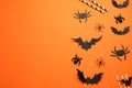 Flat lay composition with paper bats, spiders and straws on orange background, space for text. Halloween celebration Royalty Free Stock Photo