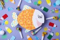 Flat lay composition with paper fish and party decor on background. April fool`s day