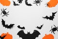 Flat lay composition with paper pumpkins, bats and spiders on white background, space for text. Halloween celebration Royalty Free Stock Photo